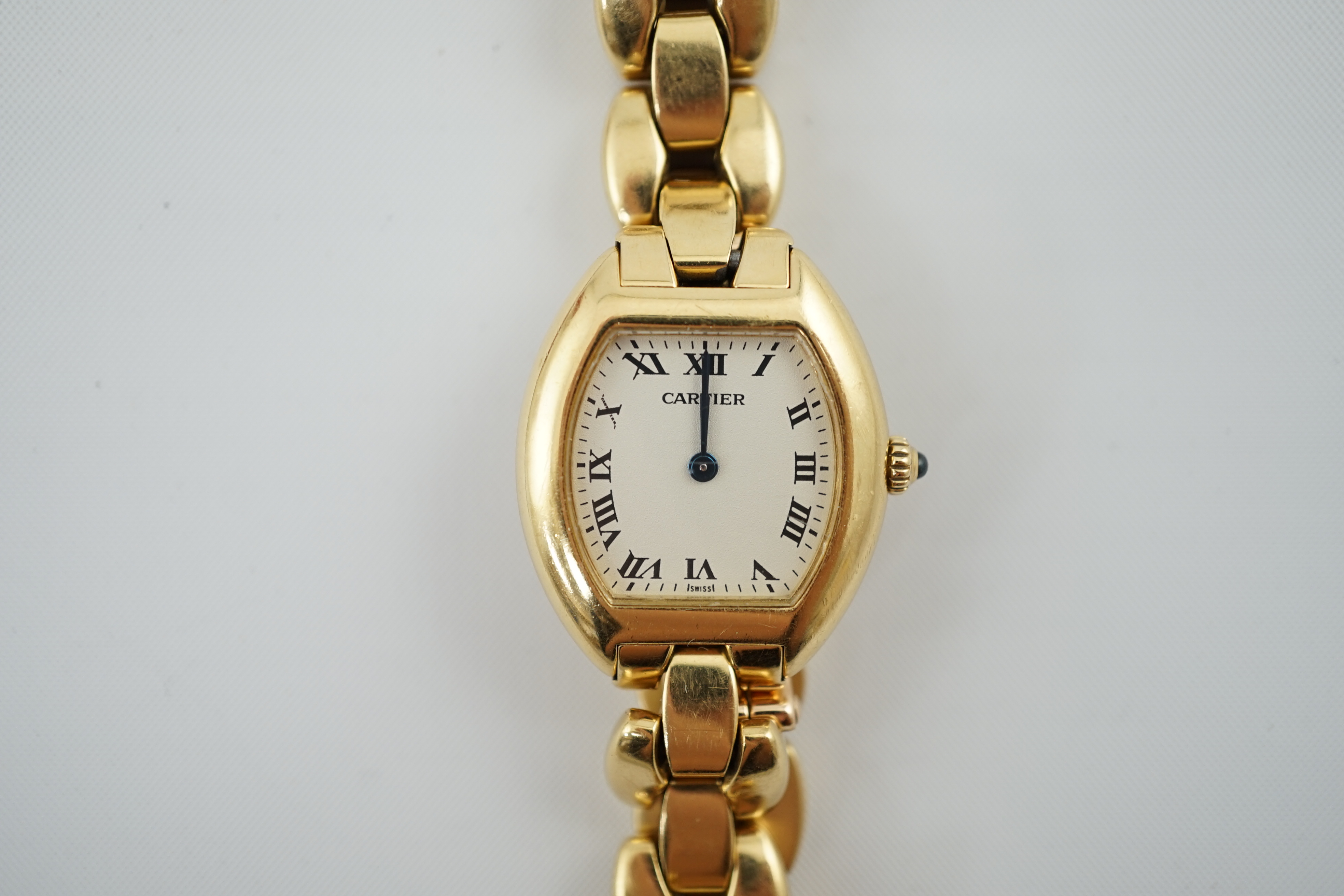 A lady's late 1990's? 18k gold Cartier quartz wrist watch, on an 18 k gold Cartier bracelet